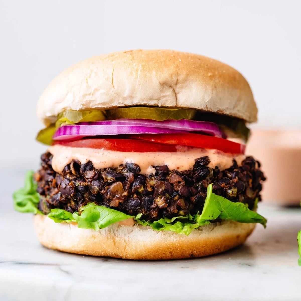 Deliciously served Vegan Black Bean Burger, a hearty vegan meal ready for a satisfying bite.