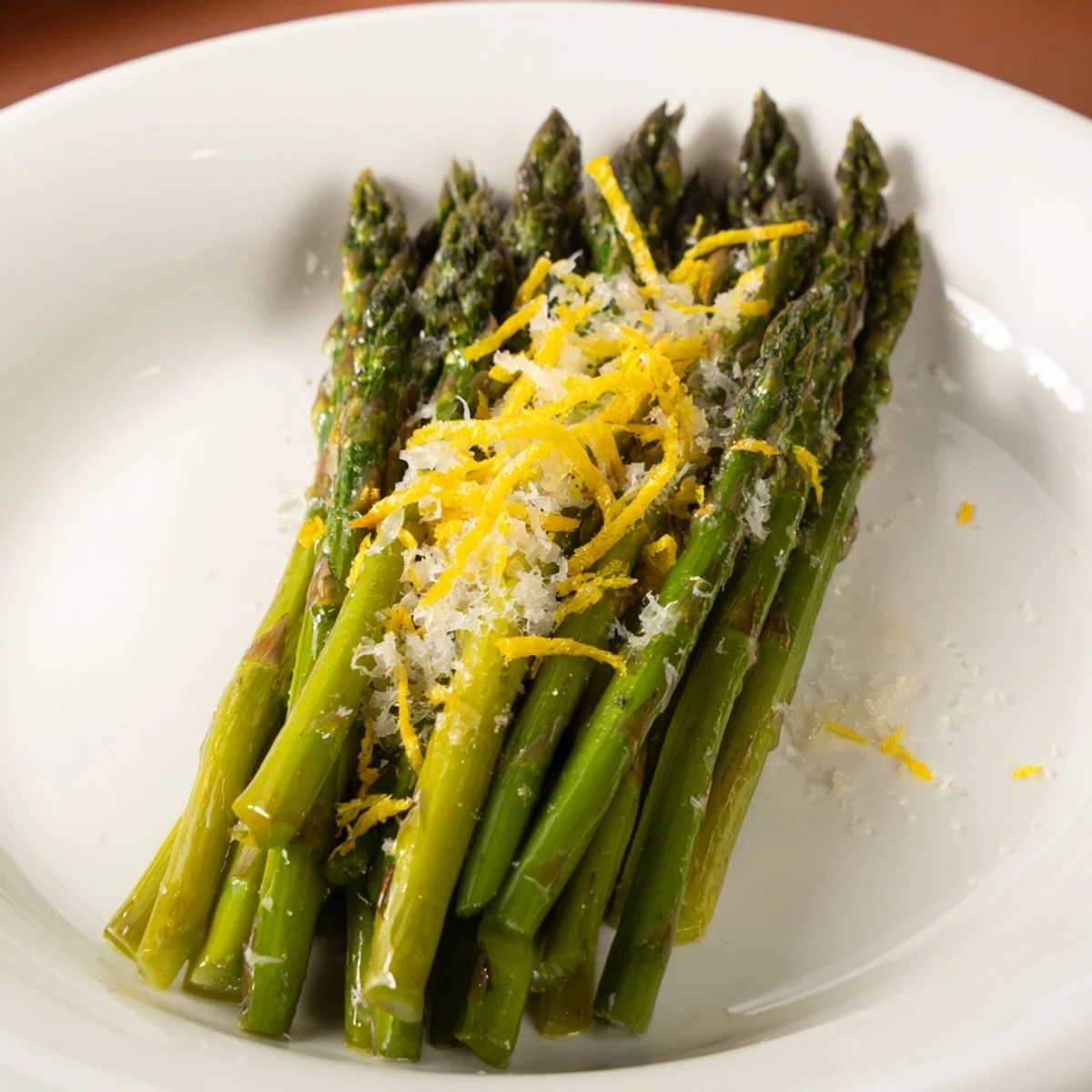 Golden roasted asparagus with Parmesan cheese and lemon, a vibrant side dish, ready to serve.