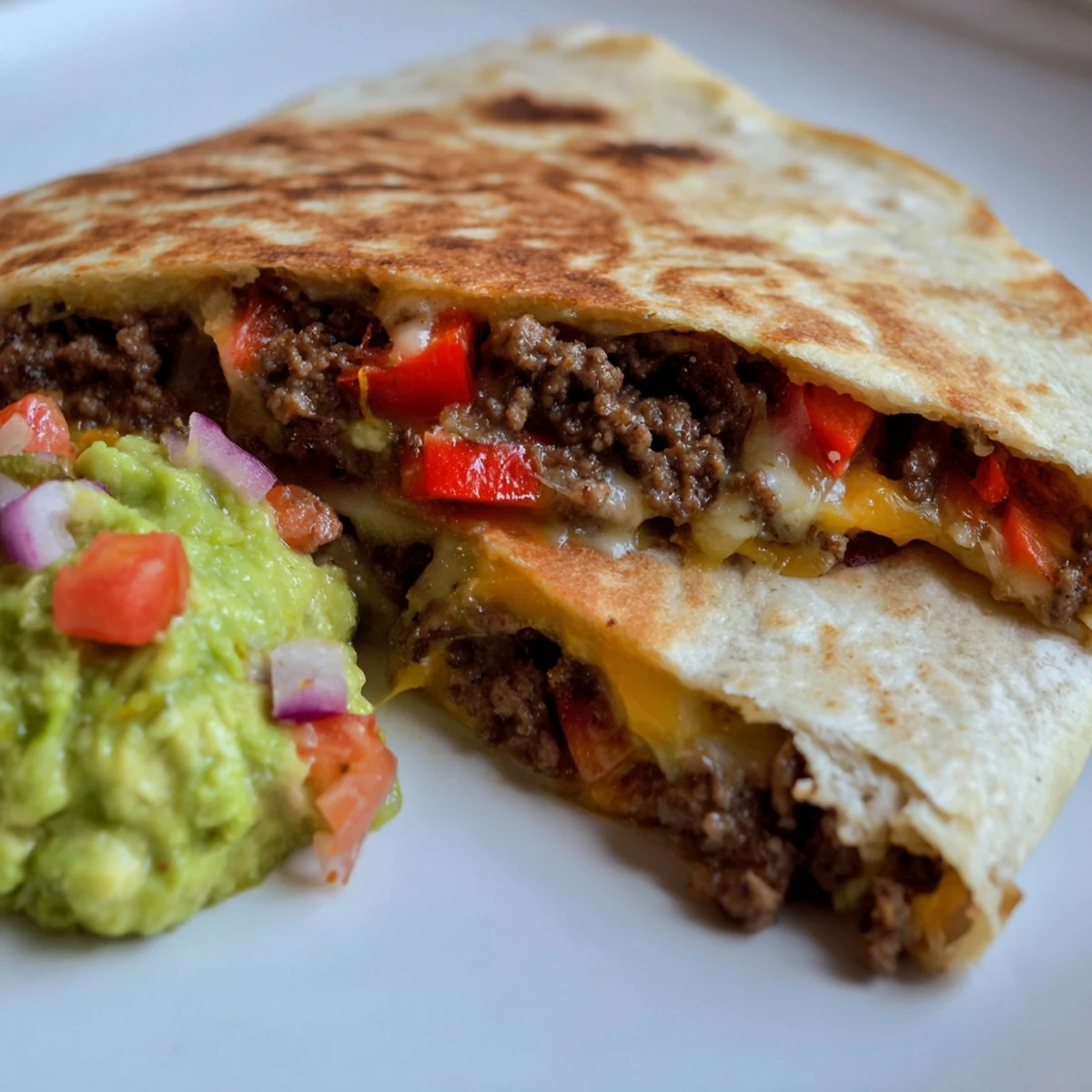 Melty cheddar and Monterey Jack cheese ooze from toasted flour tortillas.