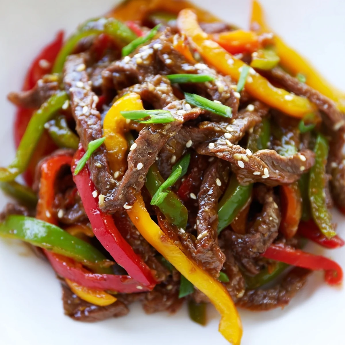 Tender beef strips and crisp red, yellow, and green peppers glistening with a bold, spicy sauce in this Spicy Beef and Pepper Stir Fry.