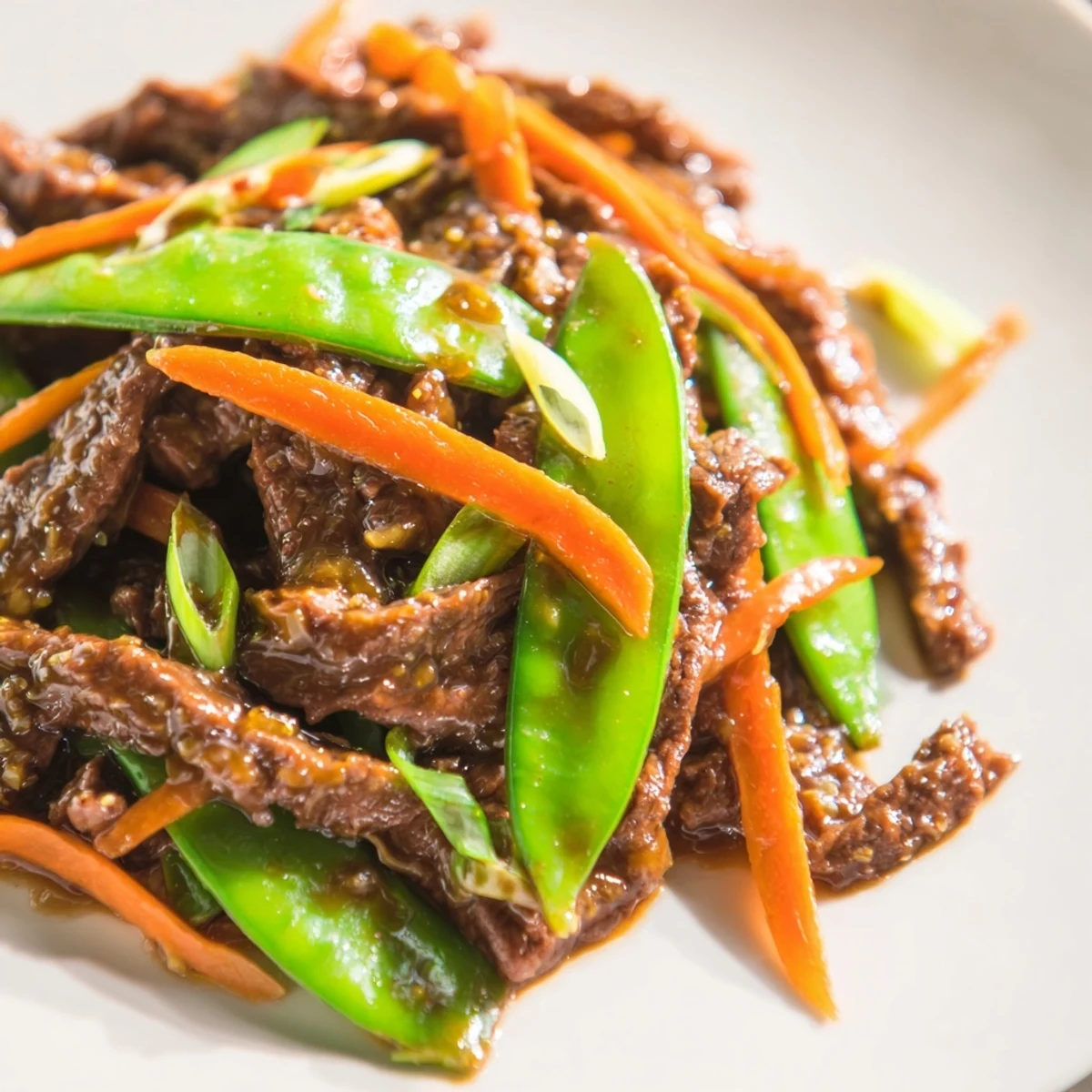 Sizzling Beef Stir Fry with Snow Peas and Carrots in a hot wok, showcasing caramelized beef and crunchy vegetables tossed in a flavorful Asian-inspired sauce.