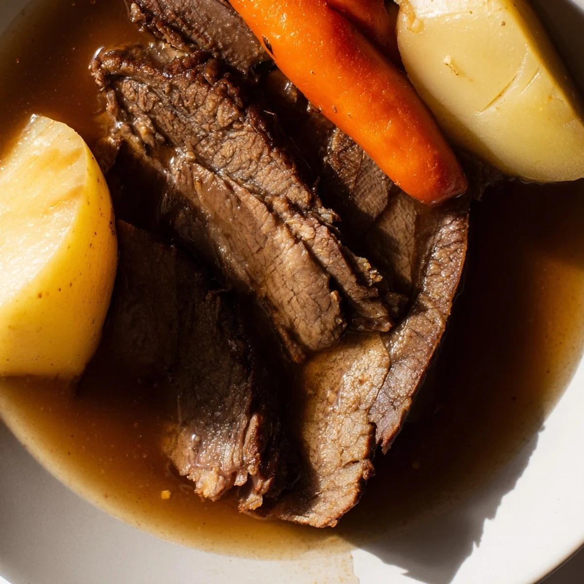 Tender Slow Cooker Pot Roast with Carrots and Potatoes, featuring soft vegetables and savory herbs.