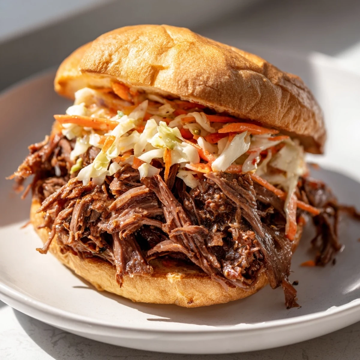 Slow-cooked pulled beef sandwiches piled high on toasted buns with tangy slaw for a satisfying dinner.