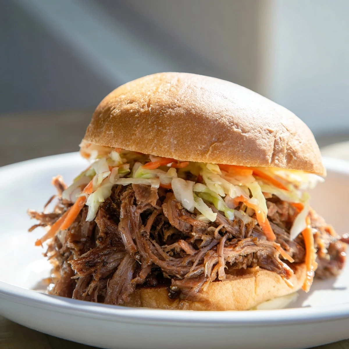 Easy slow cooker pulled beef sandwiches topped with creamy coleslaw, perfect for a family game day meal.