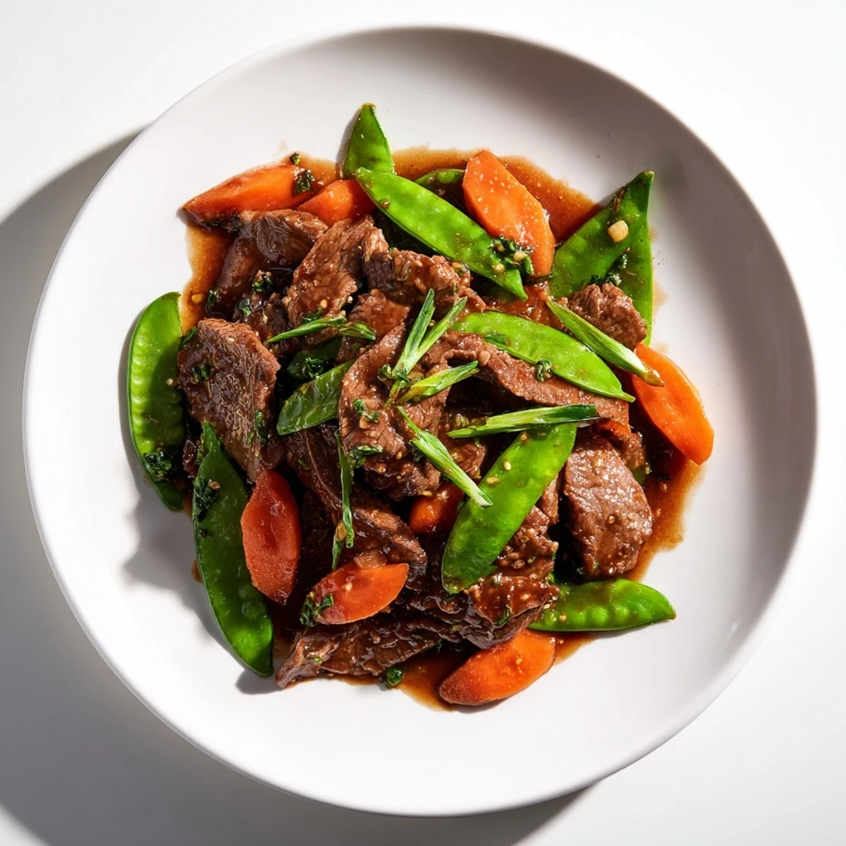 A close-up highlights glossy beef and crunchy vegetables in this easy Asian-inspired dinner.