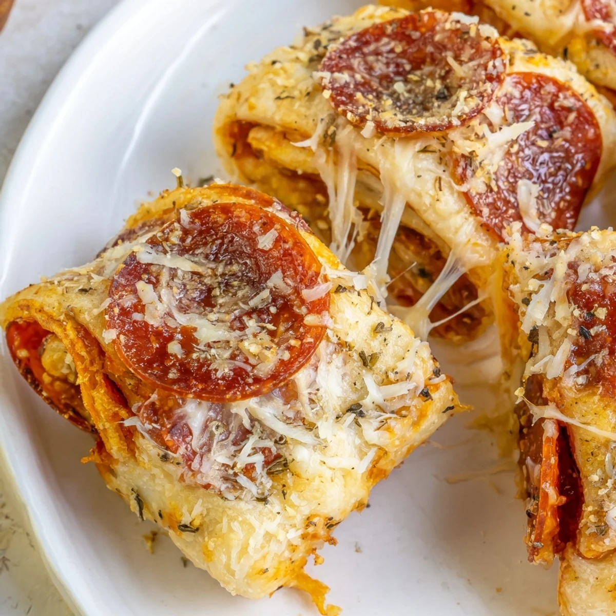 Golden-brown Game Day Pizza Rolls with Beef Pepperoni, baked and bubbling with melted mozzarella and cheddar on a rustic wooden board.