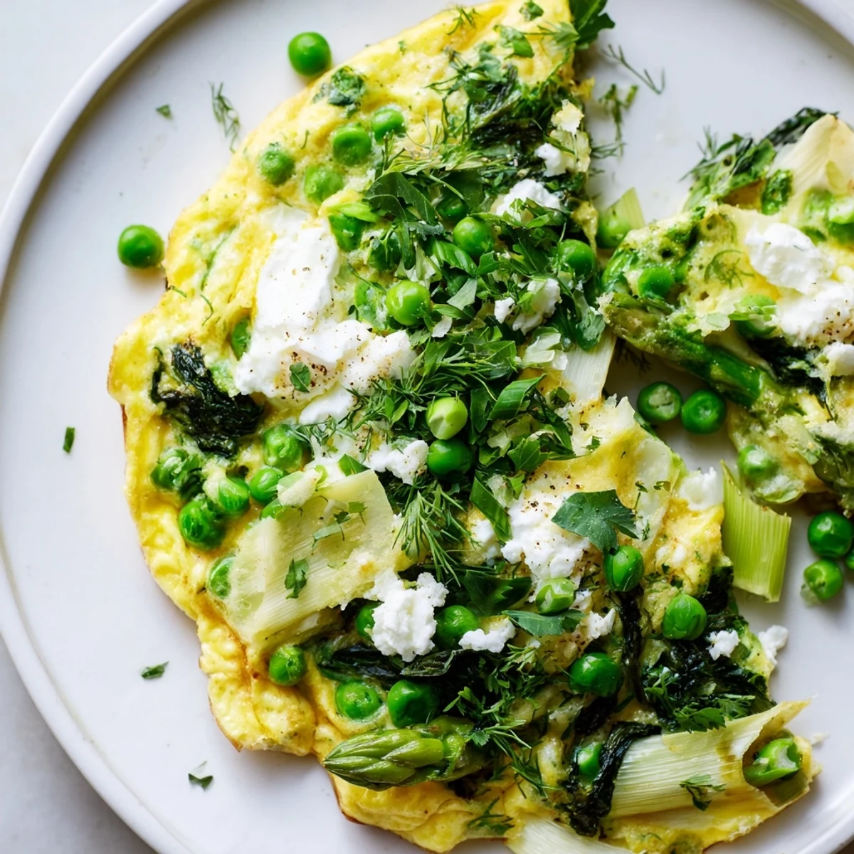 This golden-brown Spring Vegetable Frittata with Goat Cheese and Herbs is served warm on a rustic wooden board, garnished with fresh dill and chives.  