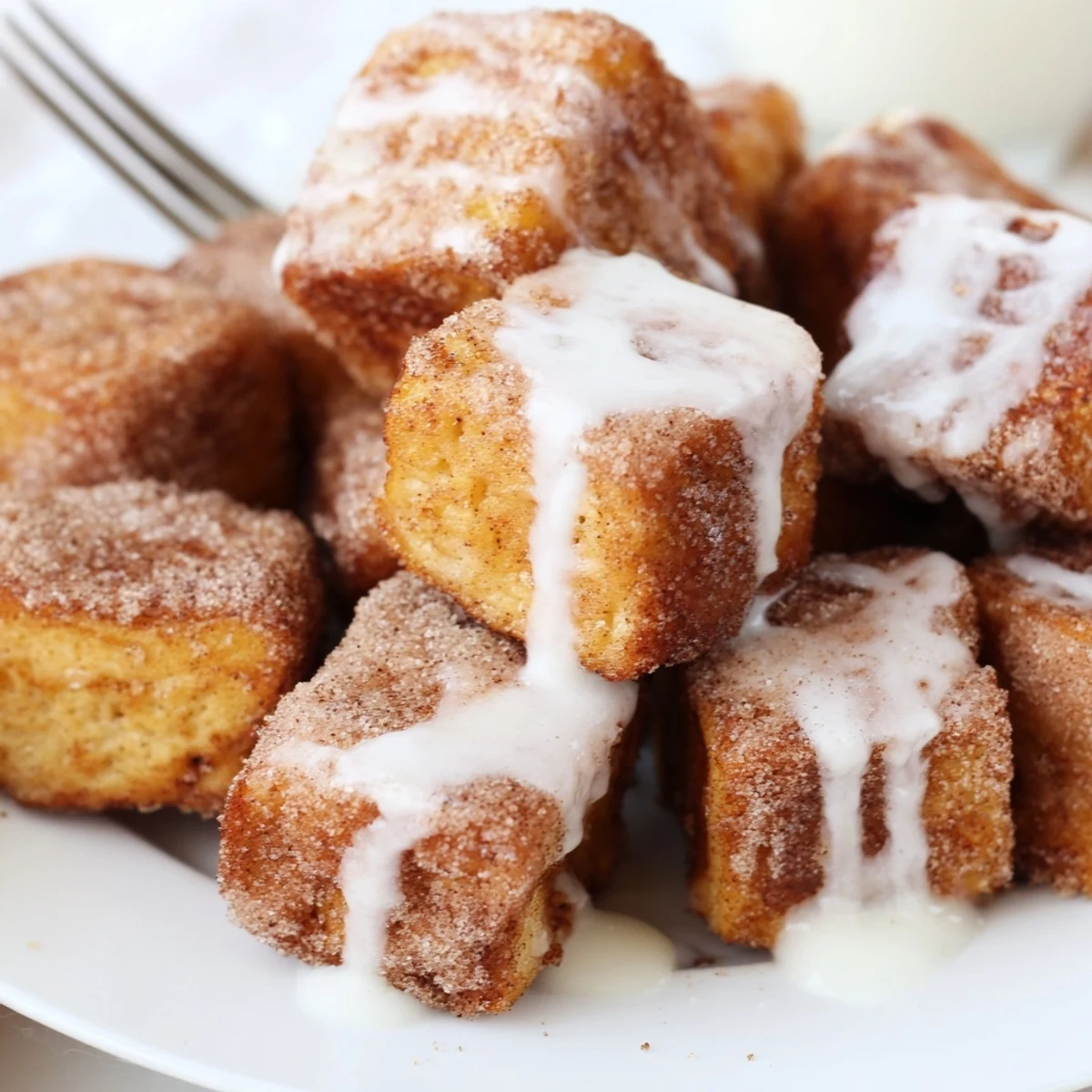 Enjoying Cinnamon Roll French Toast Bites with maple syrup and fresh berries on the side.
