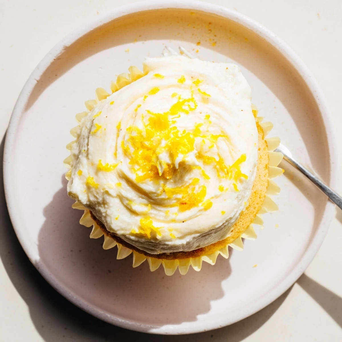 Sweet Limoncello cupcakes garnished with lemon slices and zest, perfect for spring gatherings.