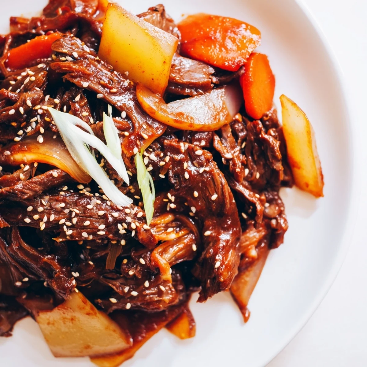 Tender beef chuck roast simmered in a rich Korean Style Pot Roast sauce with carrots and daikon.