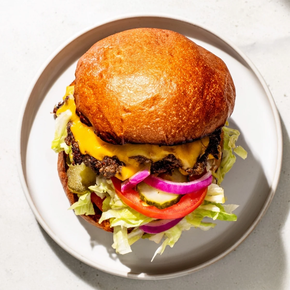 Golden crispy smash burger with melty cheese on a toasted brioche bun topped with fresh lettuce and tomato
