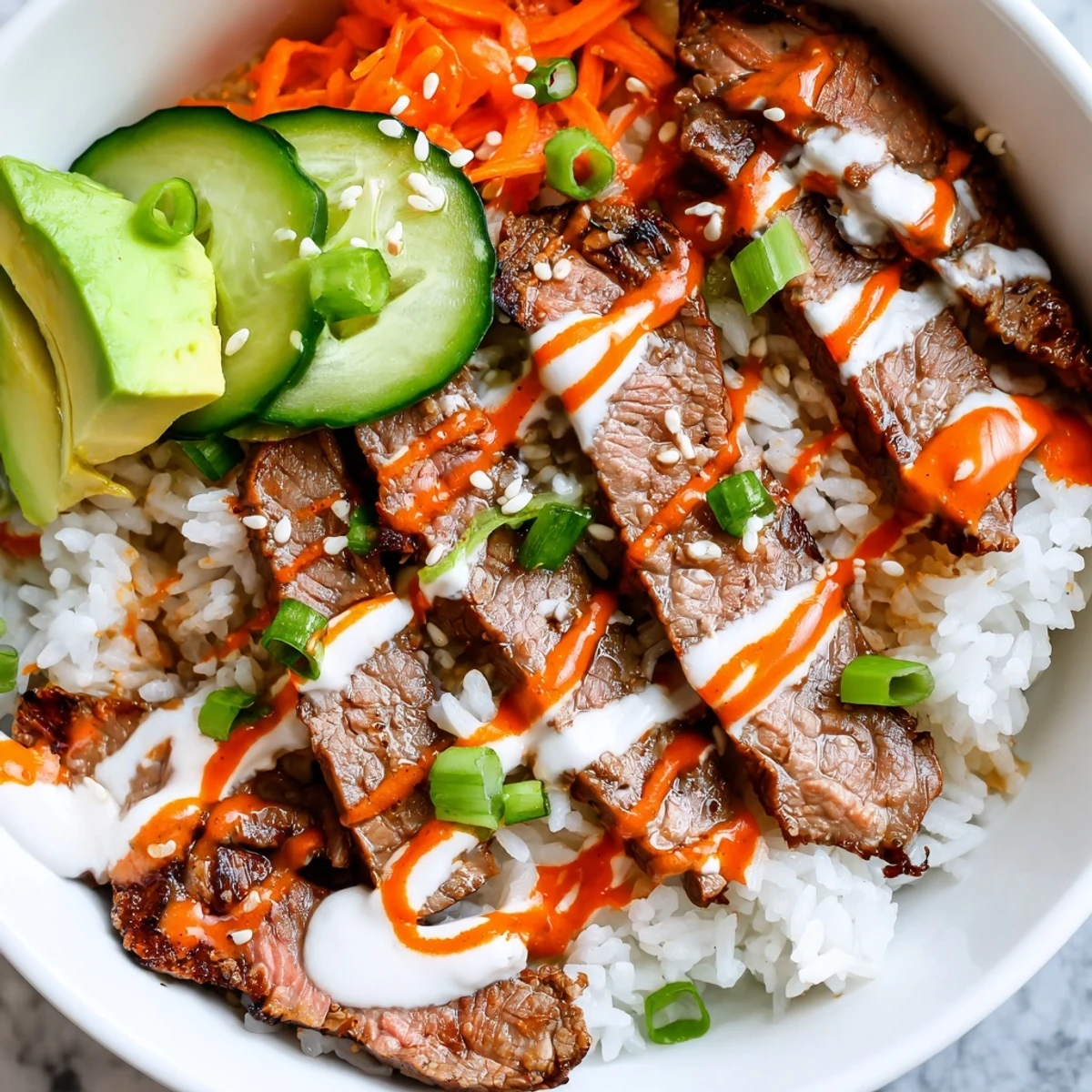 Vibrant flank steak bowl featuring marinated steak over rice with crunchy vegetables and sesame seeds