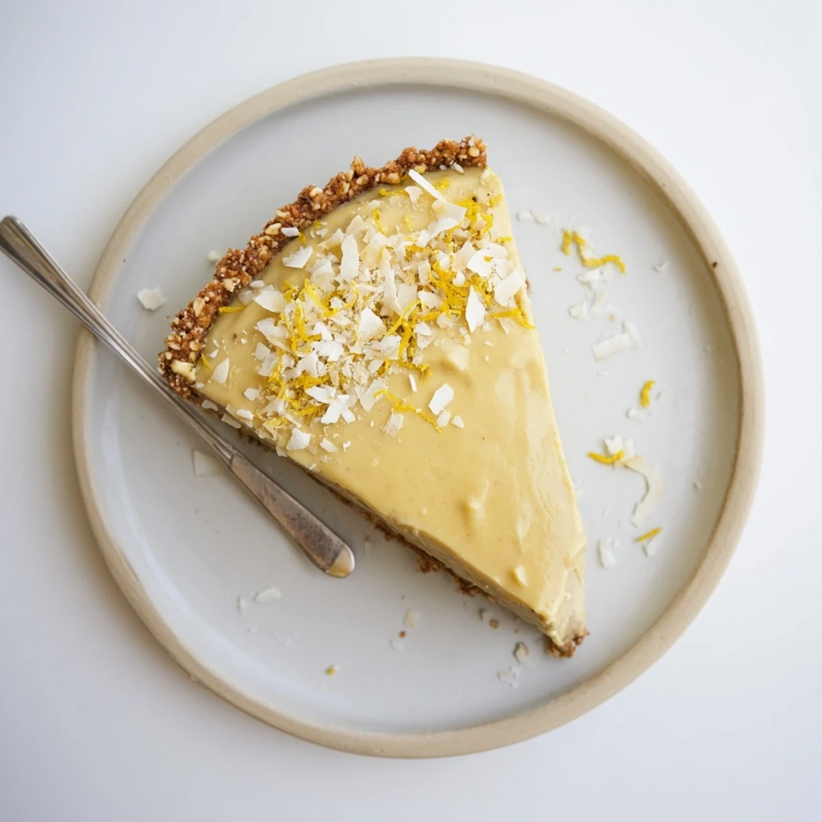 Bright yellow no bake vegan lemon tart with coconut cream and maple syrup
