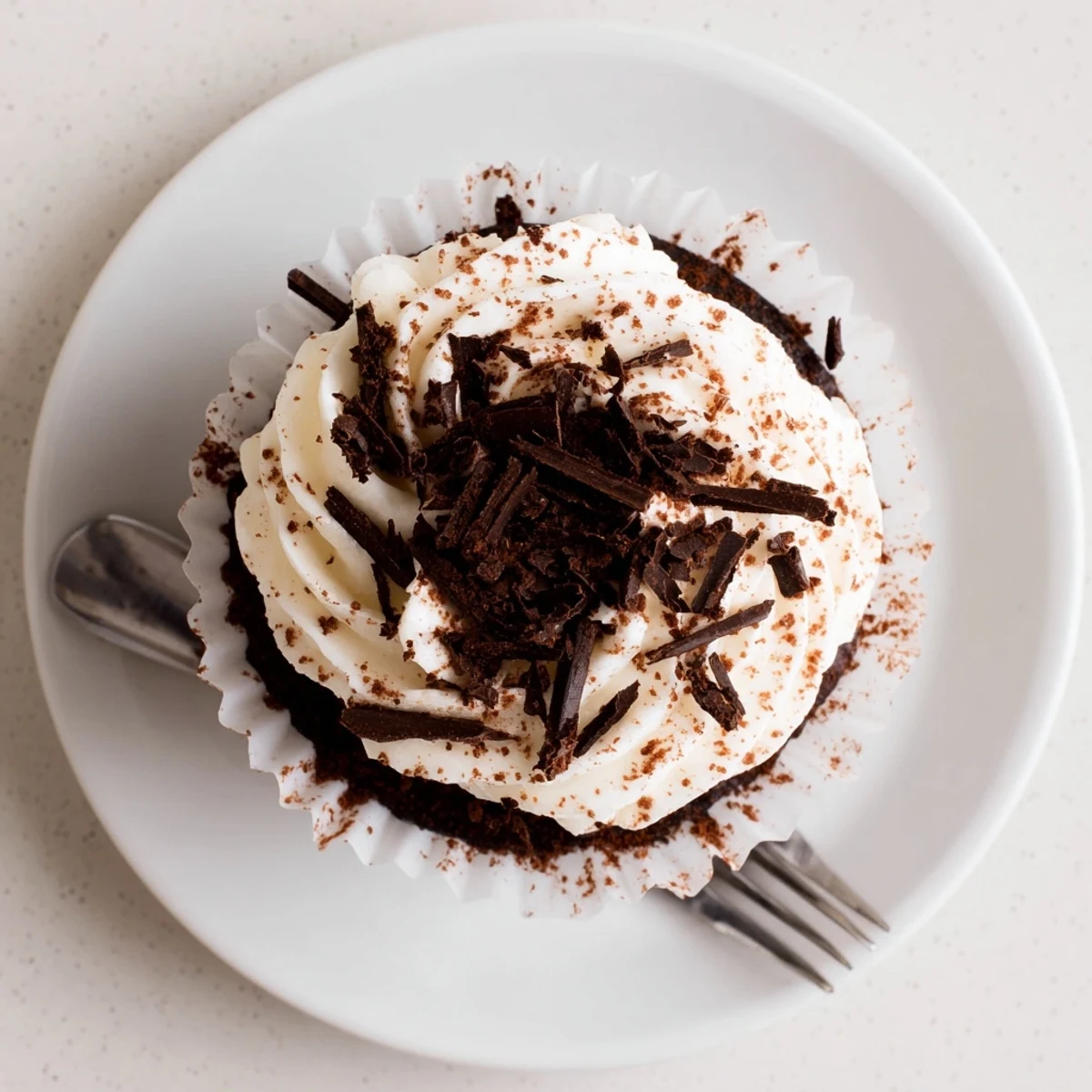 Decadent chocolate tiramisu cupcakes topped with fluffy mascarpone frosting and dusted cocoa powder