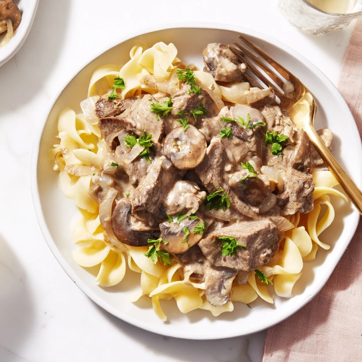 Creamy beef stroganoff with tender beef strips and mushrooms over egg noodles