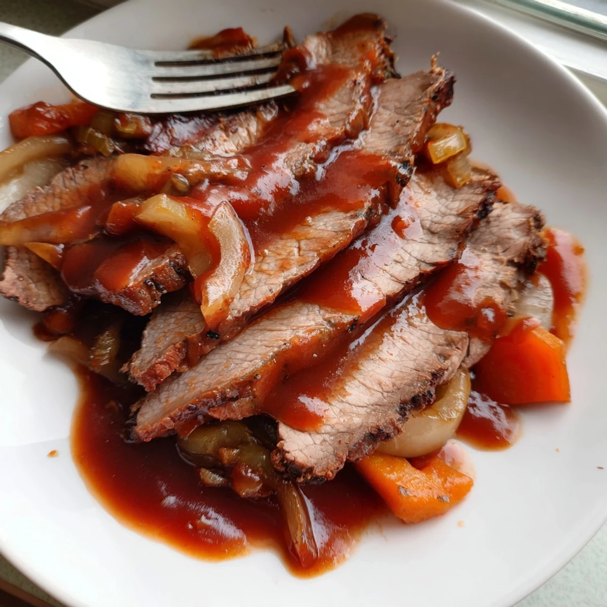 Sliced slow cooker beef brisket served with roasted vegetables and drizzled with rich savory sauce