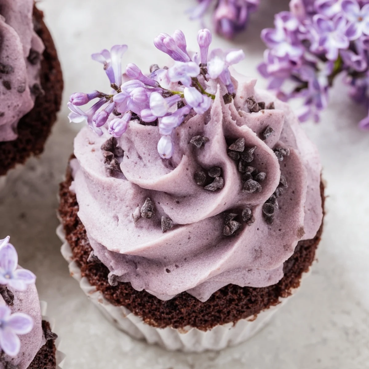 Small batch lilac chocolate cupcakes topped with floral buttercream and fresh purple blossoms