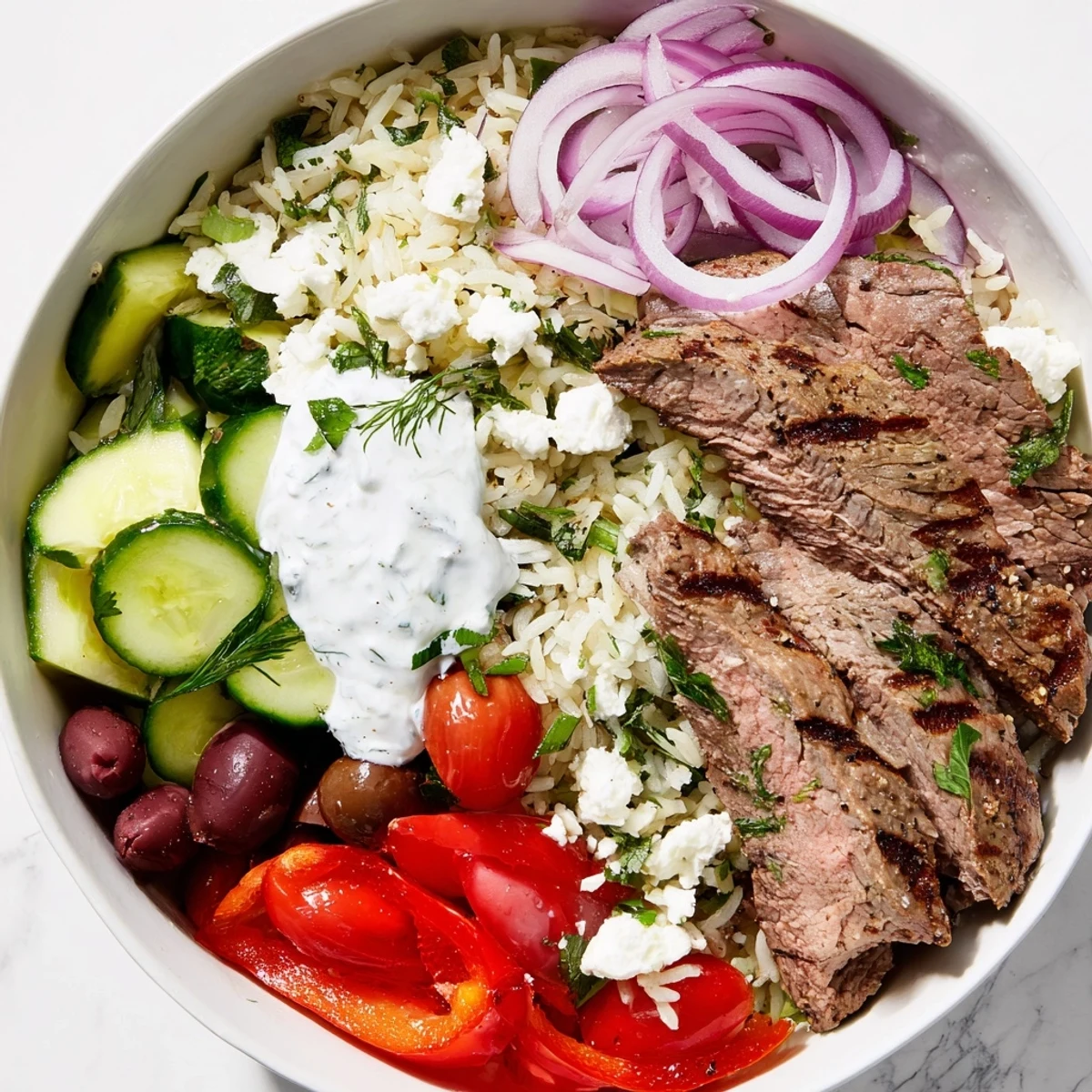 Golden grilled steak slices atop fluffy herbed rice with fresh vegetables and tangy yogurt sauce