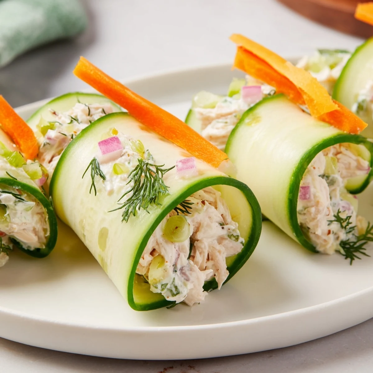 Fresh cucumber ribbons wrapped around creamy chicken salad for a light, gluten-free appetizer