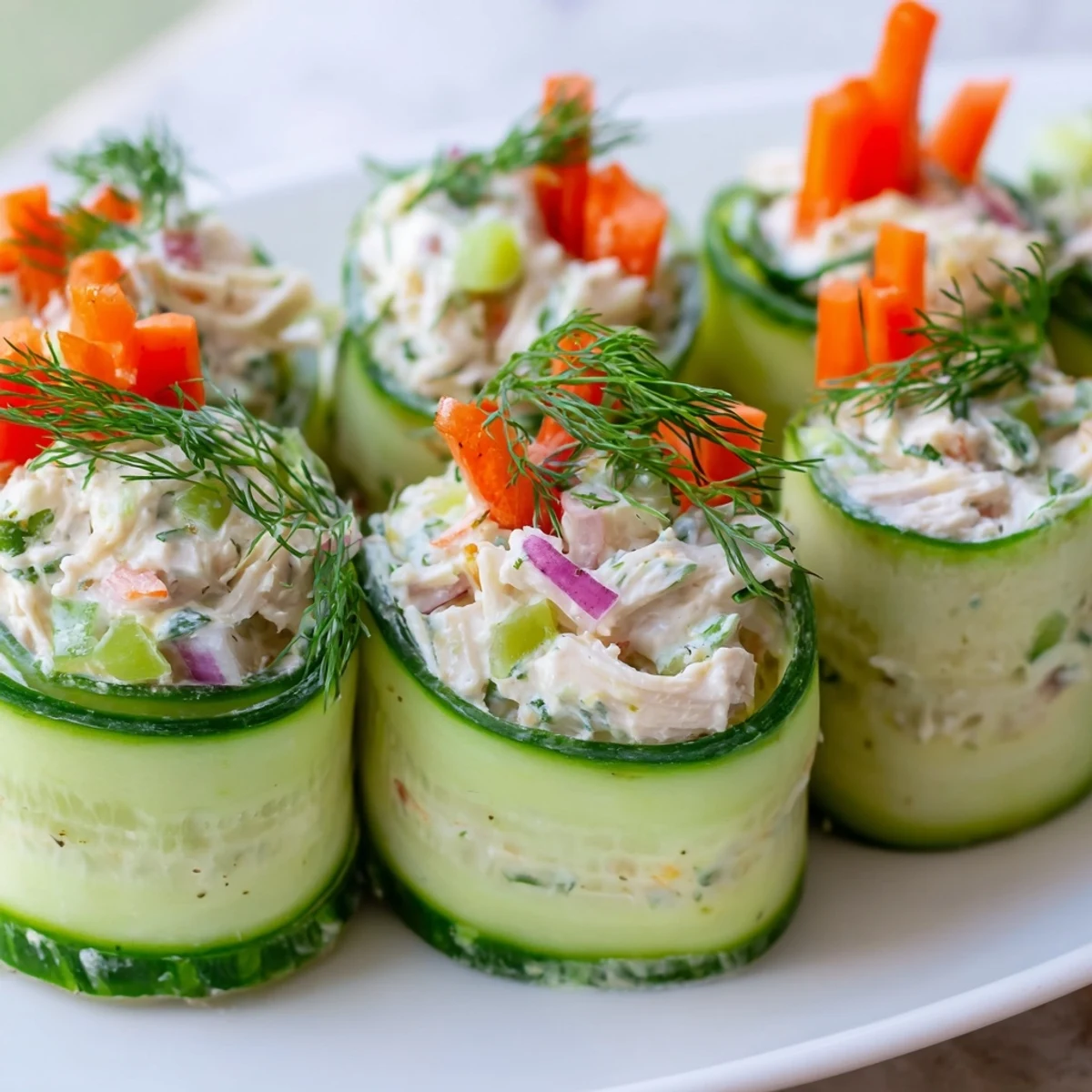 Crisp cucumber slices filled with savory chicken salad create these easy low-carb roll ups