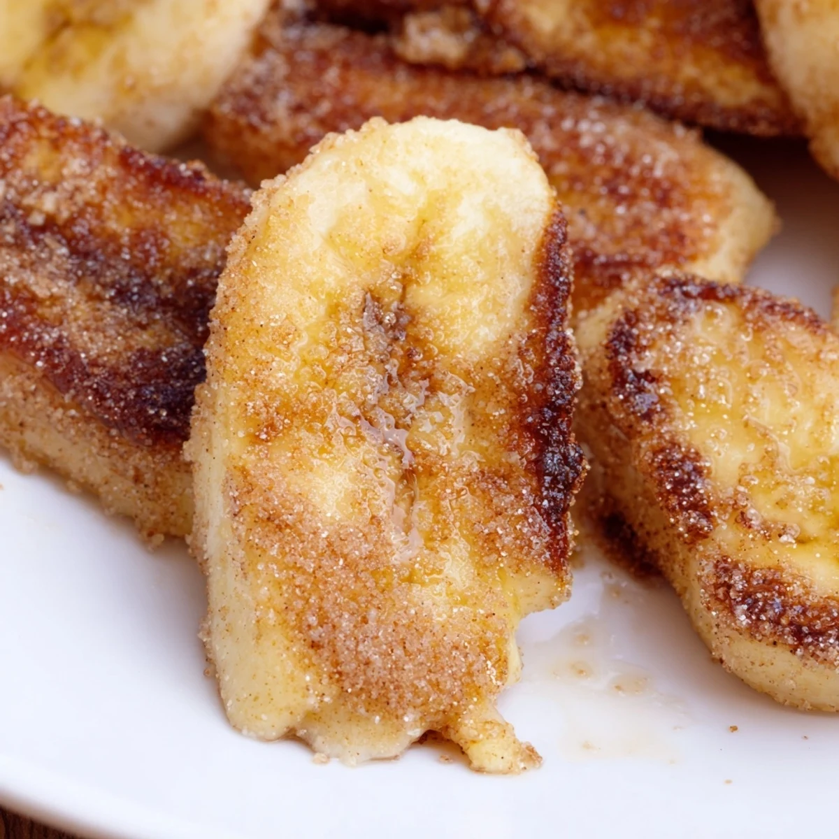 Golden pan fried cinnamon bananas caramelized to perfection in a skillet with brown sugar