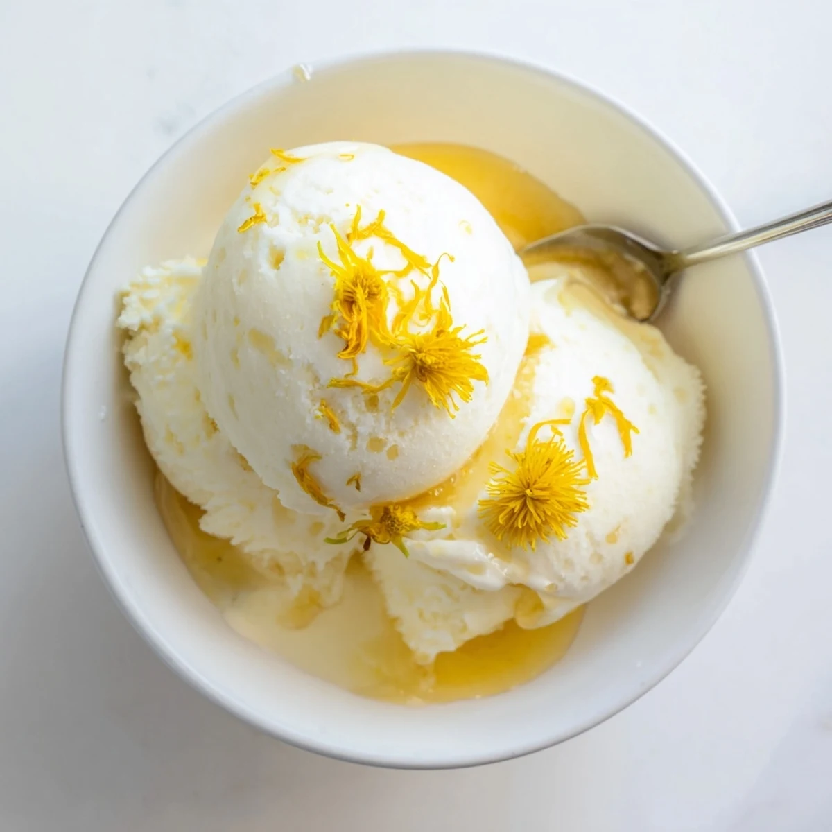 Velvety floral ice cream bowl garnished with edible dandelion flowers and honey swirl