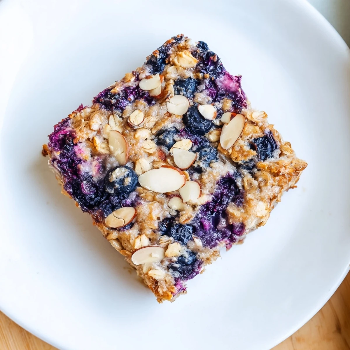 Creamy baked oatmeal breakfast casserole dotted with plump blueberries and sprinkled with toasted almond slices