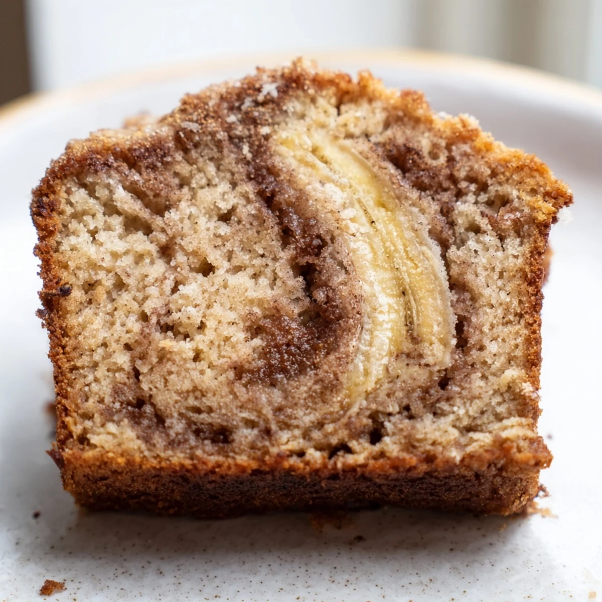 Warm cinnamon sugar swirl banana bread with golden crust and tender marbled crumb