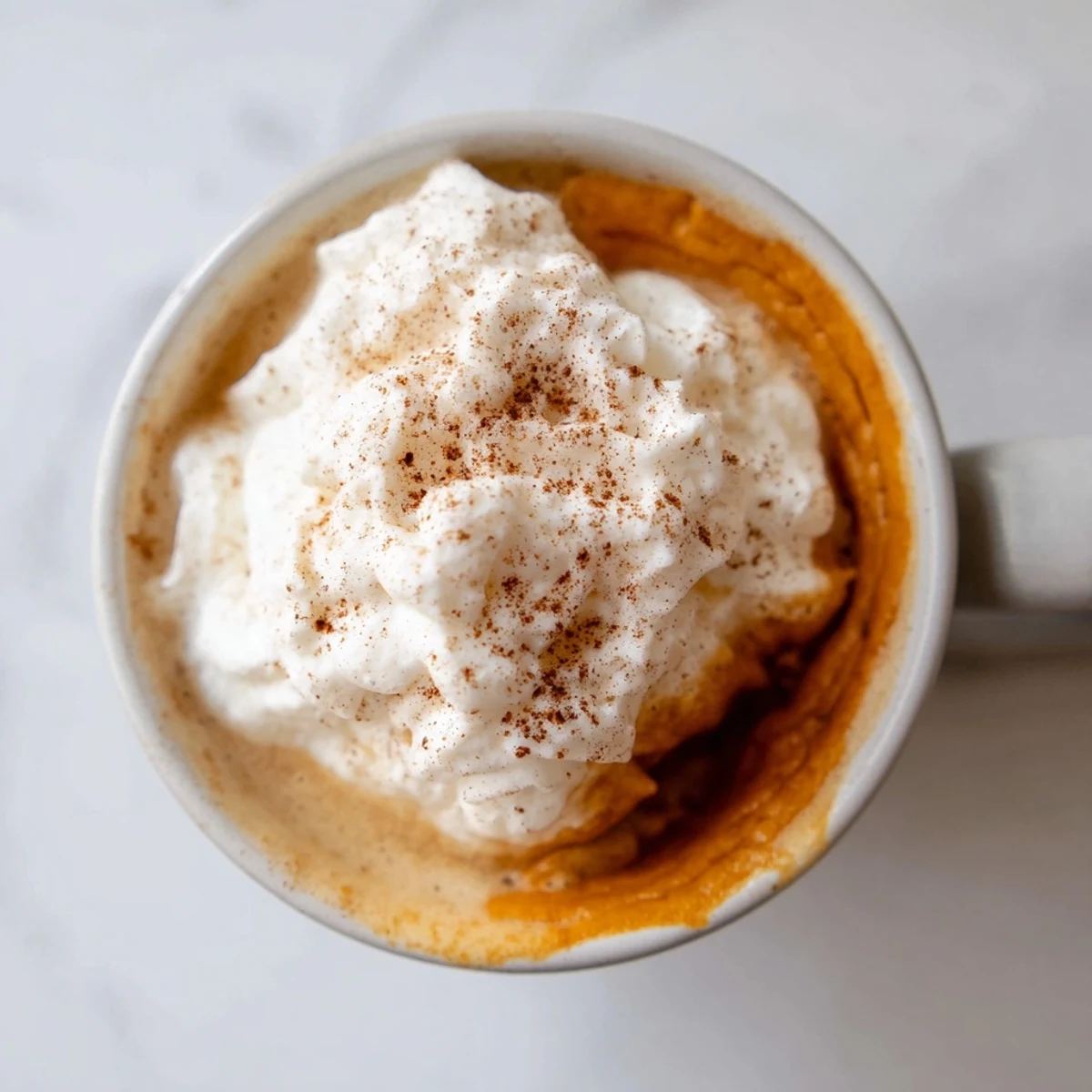Warm homemade pumpkin spice latte in a cozy mug on a crisp autumn morning
