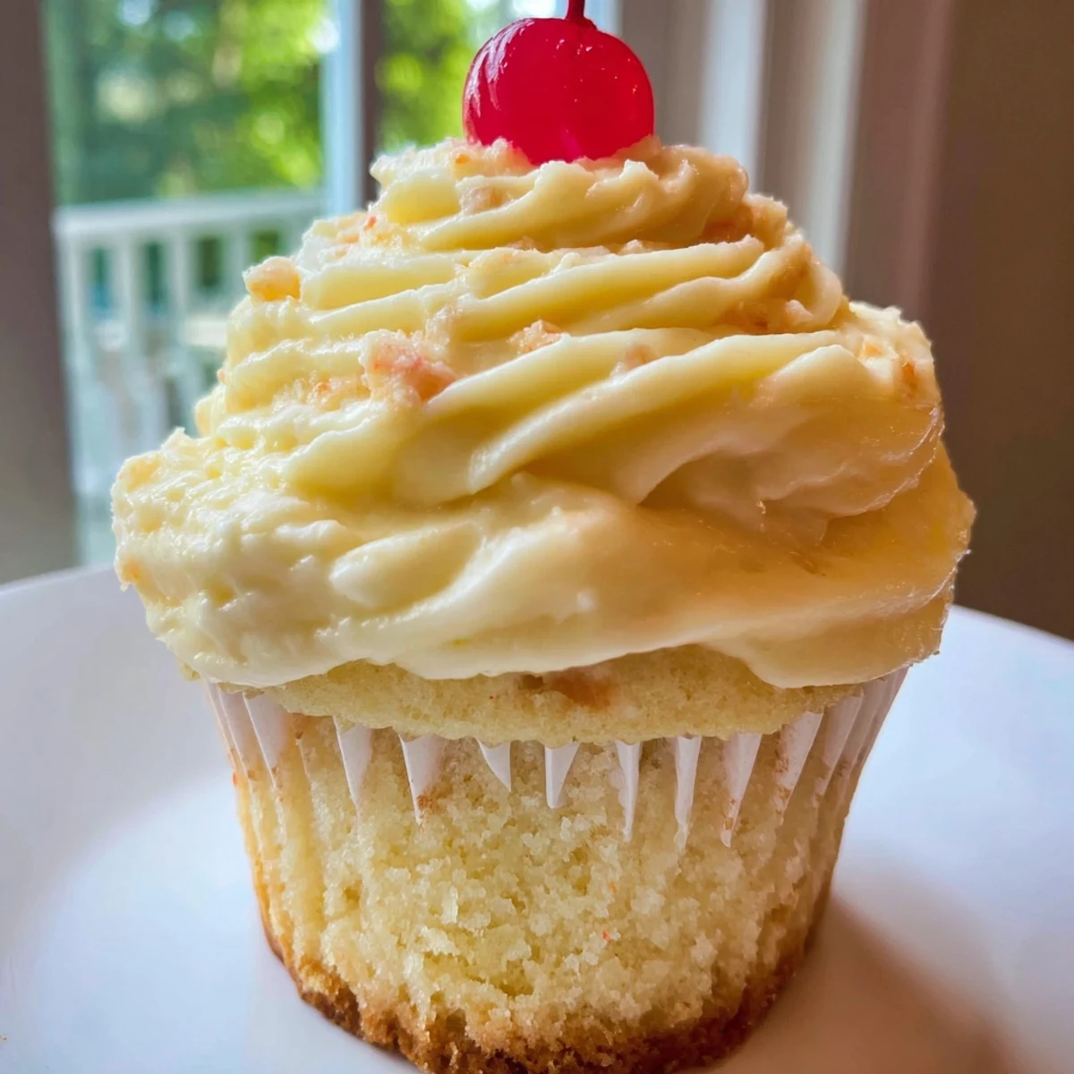 A batch of Dole Whip Cupcakes with tall whipped pineapple frosting and pineapple wedge toppers