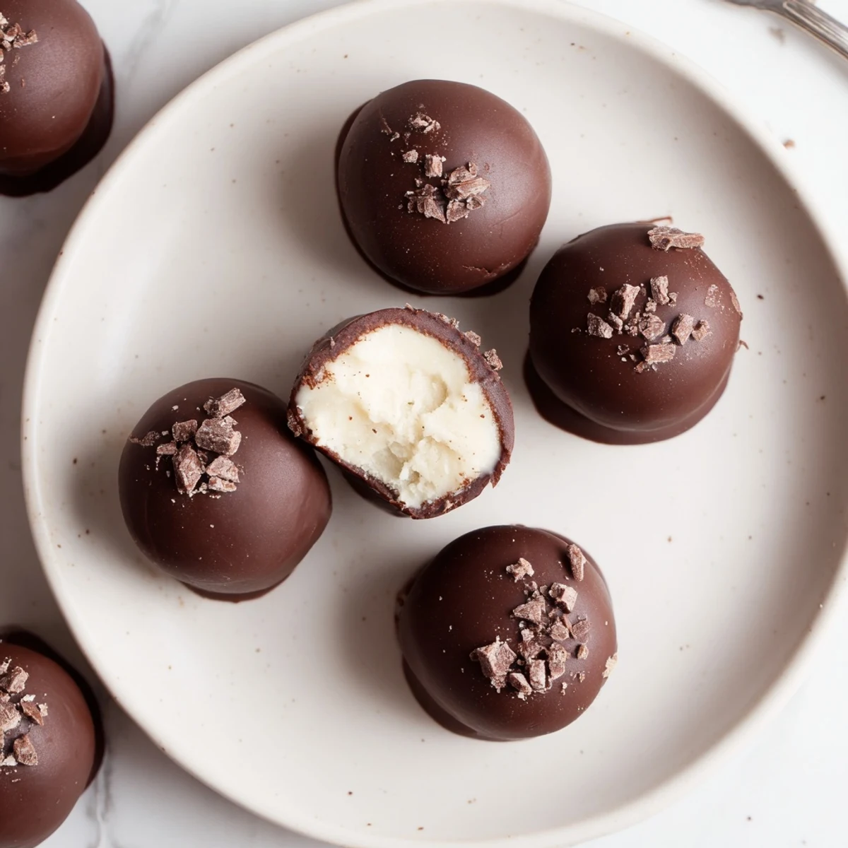 Bitten Dark Chocolate Eggnog Truffles show silky eggnog ganache, warmly spiced and chilled