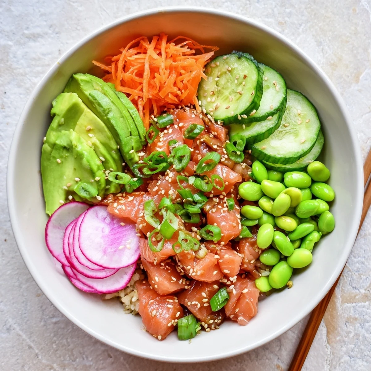 Fresh Hawaiian poke bowl featuring marinated salmon, creamy avocado slices, and crisp vegetables