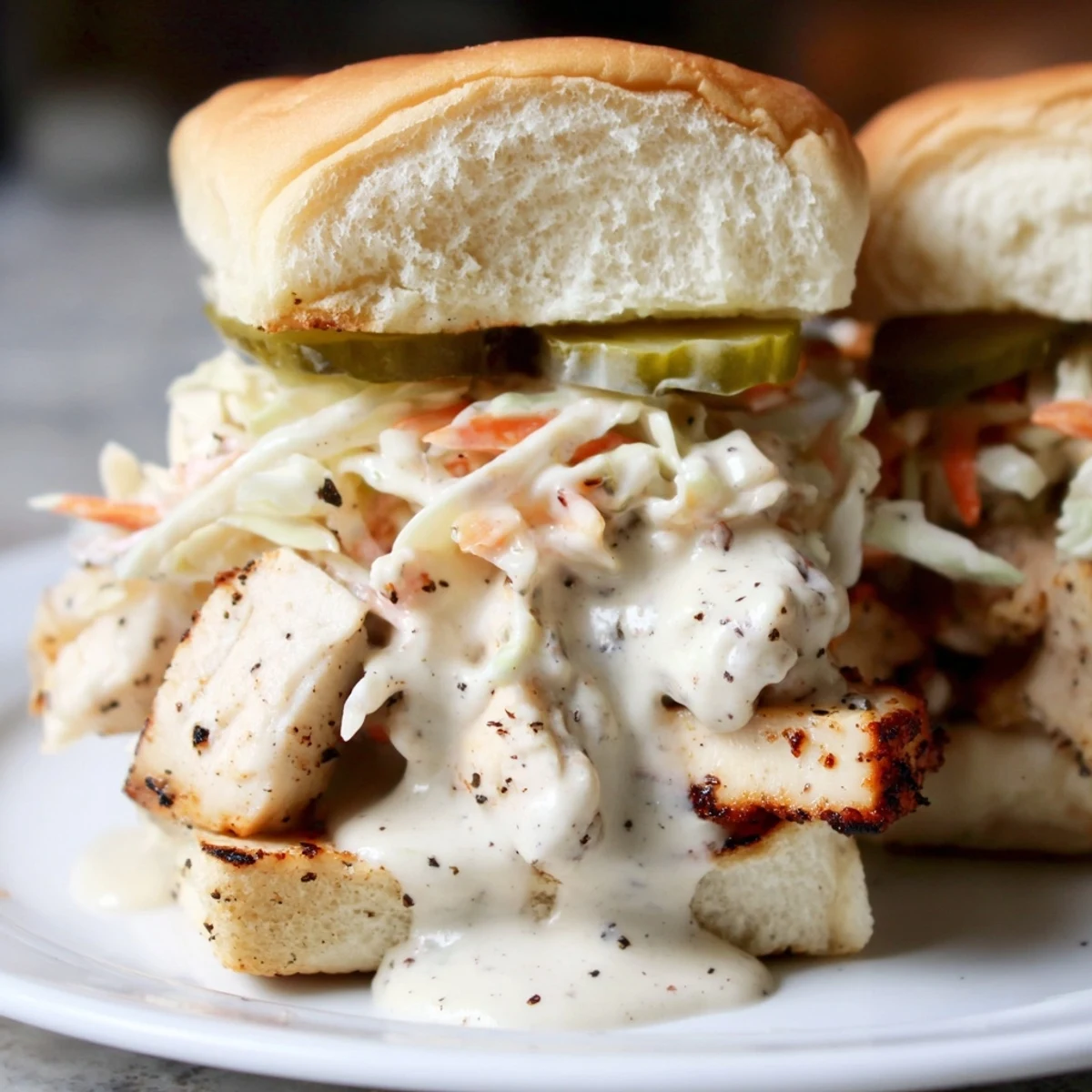 Chopped grilled chicken tossed in tangy Alabama white BBQ sauce piled onto a sandwich bun