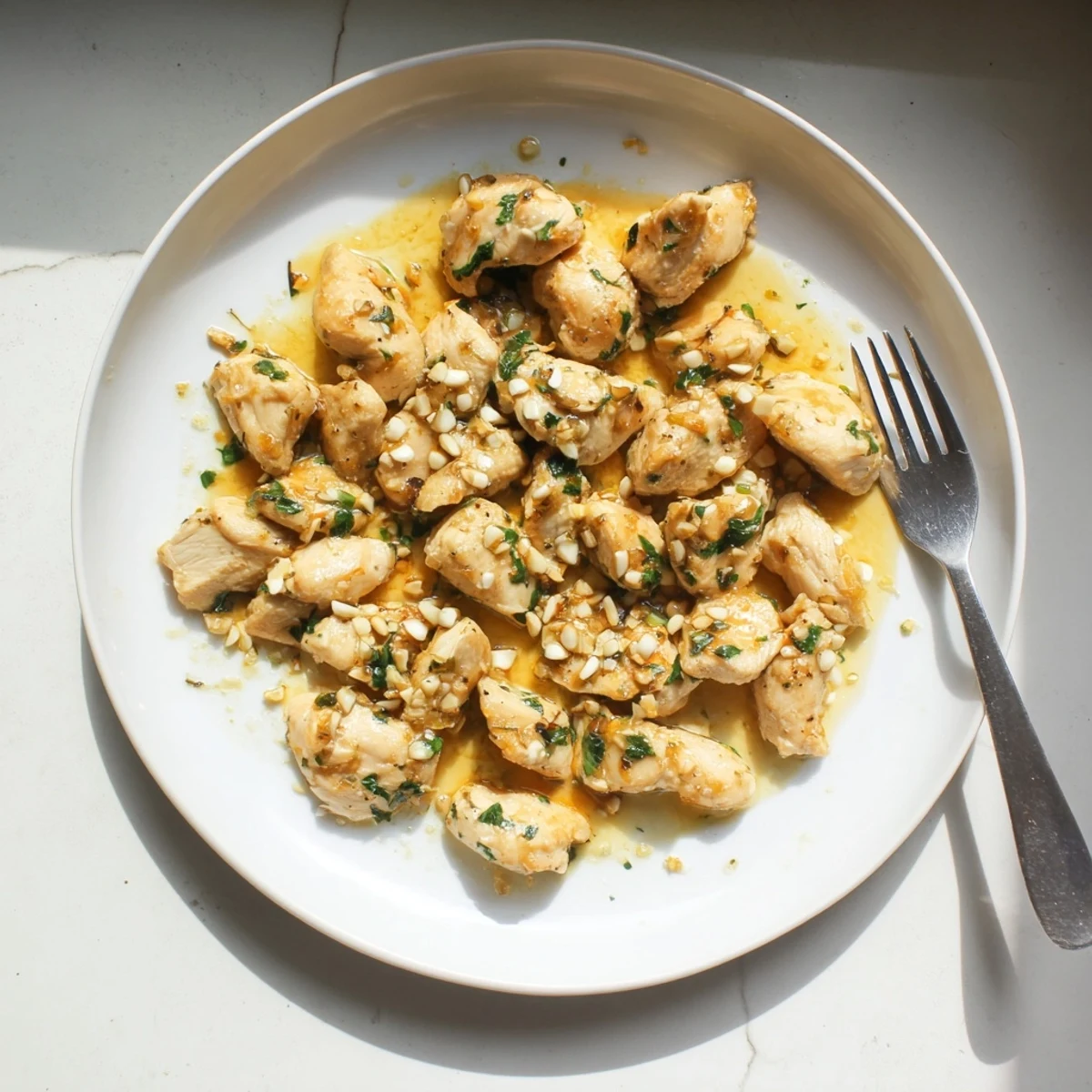 Crispy golden brown chicken bites coated in rich buttery garlic glaze served as appetizer