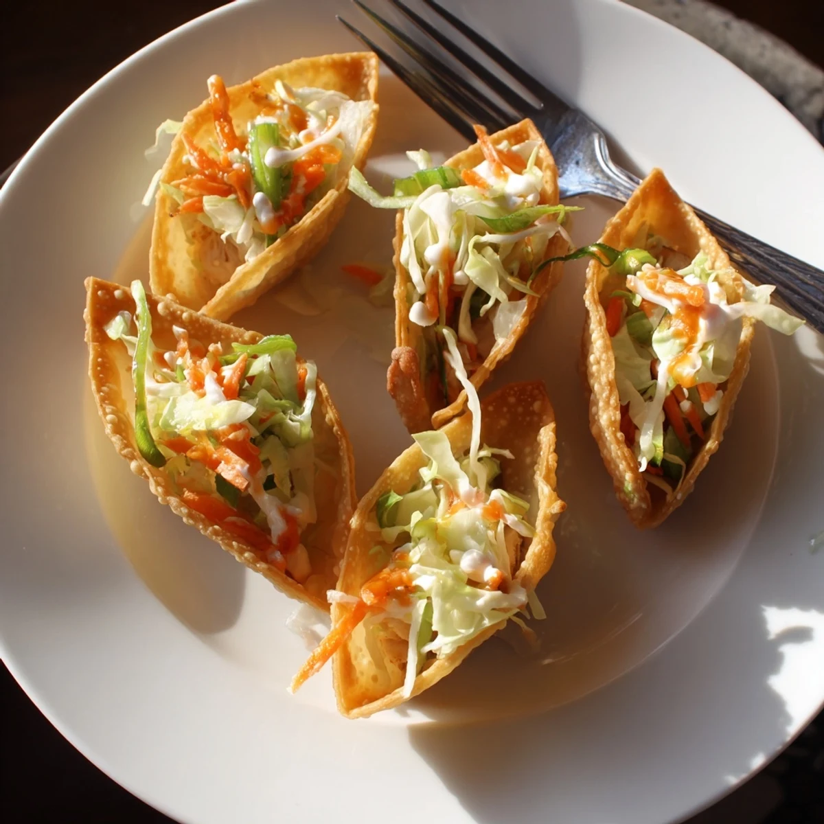 Fusion handheld Asian chicken wonton tacos filled with savory stir-fried meat and fresh cabbage vegetable slaw