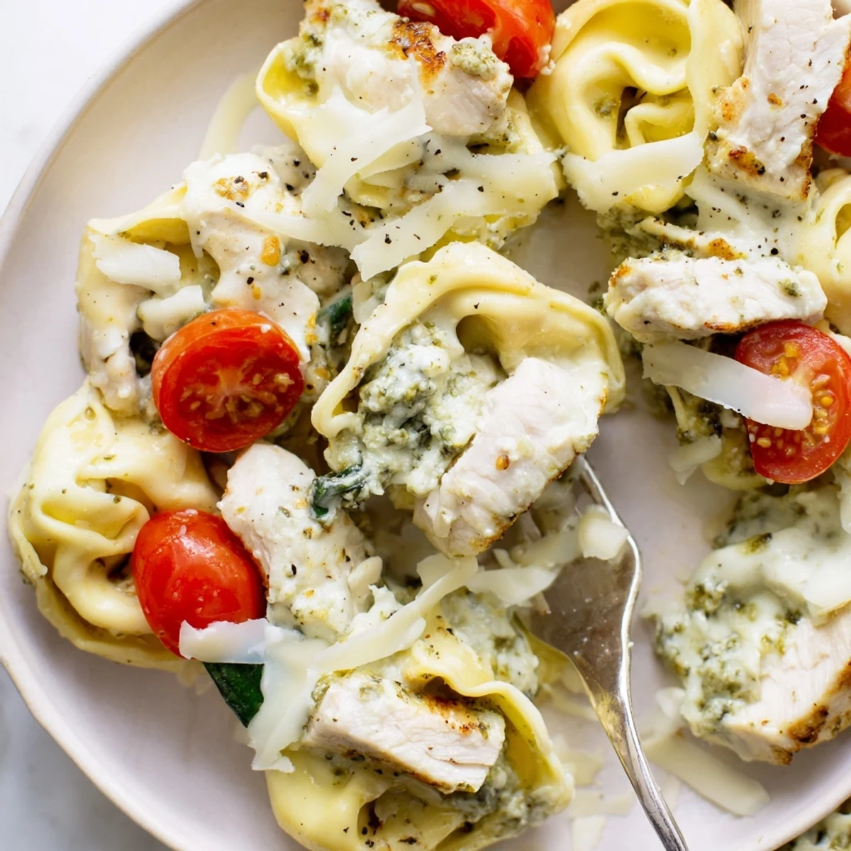 Slow Cooker Tortellini Casserole With Cheesy Chicken Pesto bubbling with golden, melty cheese