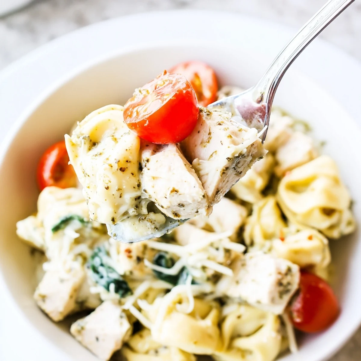 Creamy Slow Cooker Tortellini Casserole With Cheesy Chicken Pesto, basil aroma and melted mozzarella