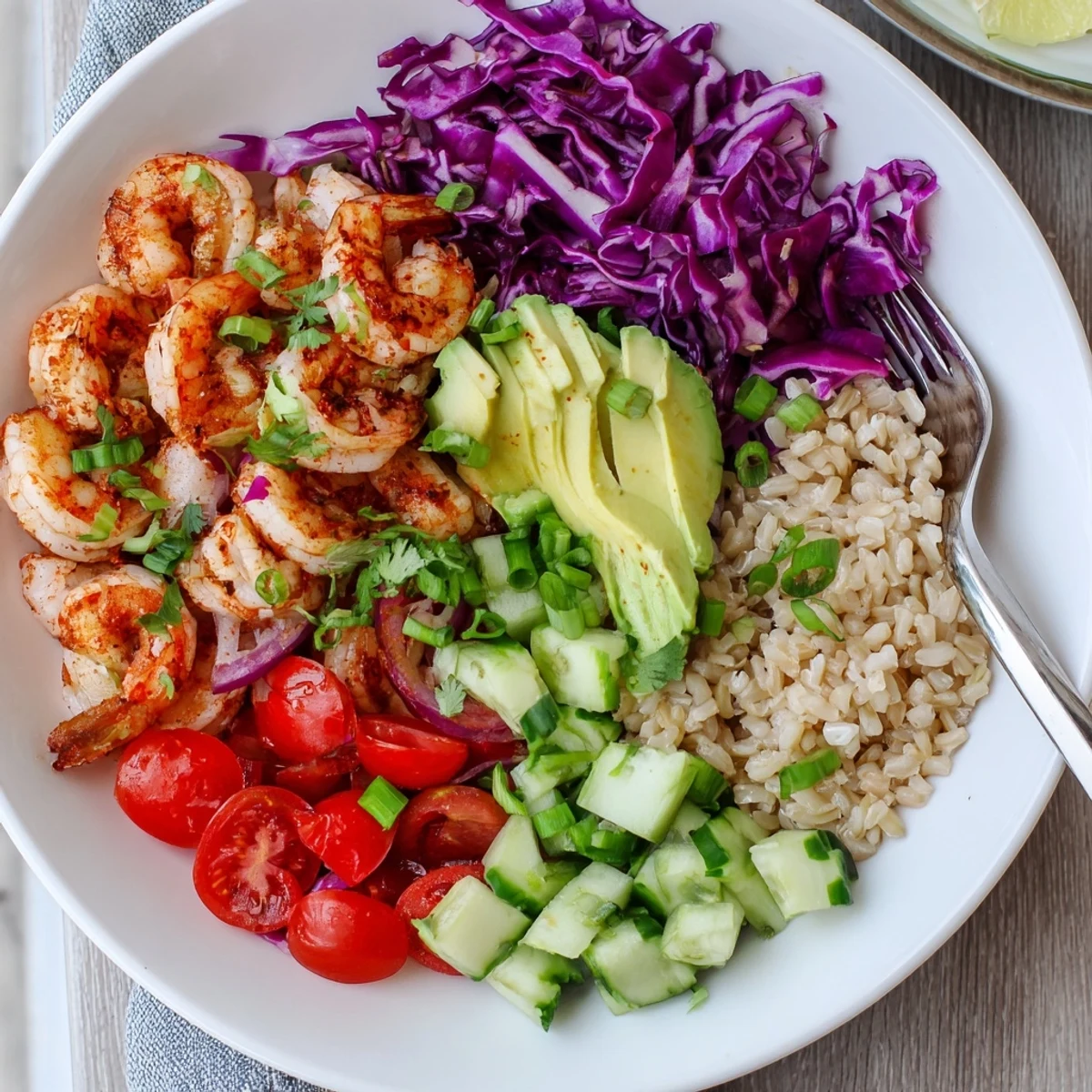 Hearty shrimp grain bowl served over brown rice with vibrant crunchy vegetables