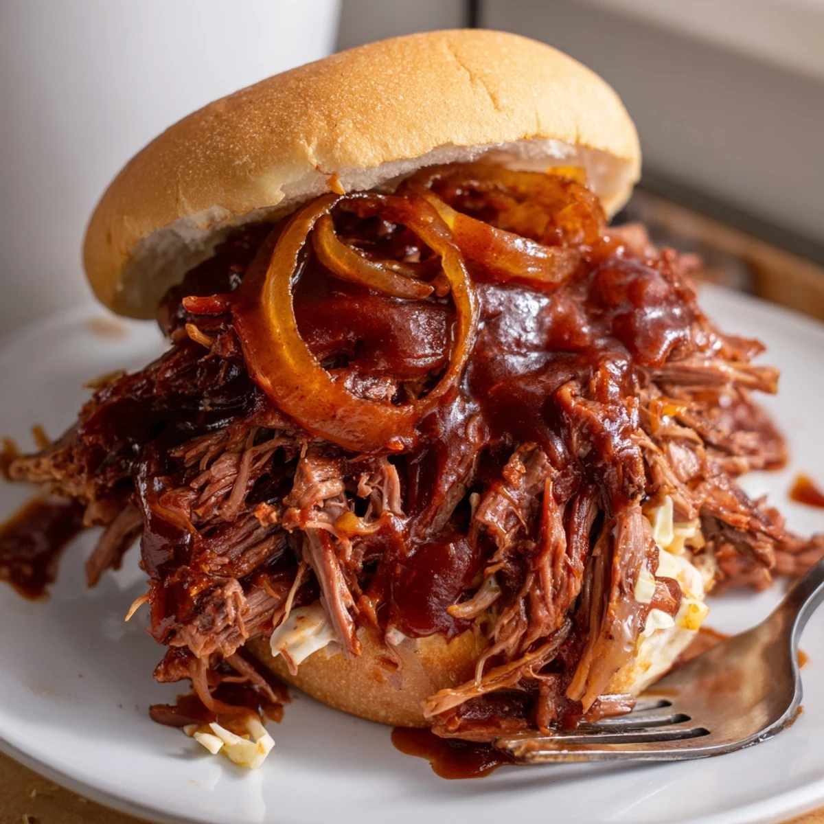 Slow Cooker BBQ Pulled Beef falling apart with a fork, served over fluffy white rice