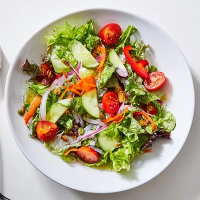 Bright Garden Salad tossed in Dijon vinaigrette, crunchy cucumbers and shredded carrot