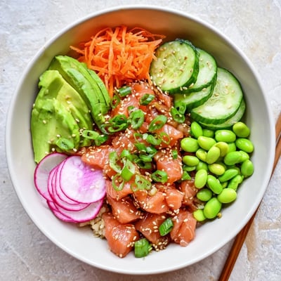 Fresh Hawaiian poke bowl featuring marinated salmon, creamy avocado slices, and crisp vegetables