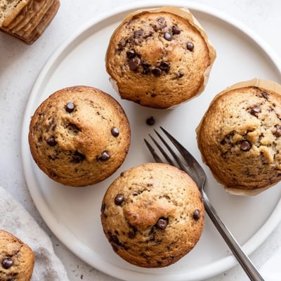 Batch of moist banana espresso chocolate chip muffins cooling on wire rack, ready for breakfast or snacking