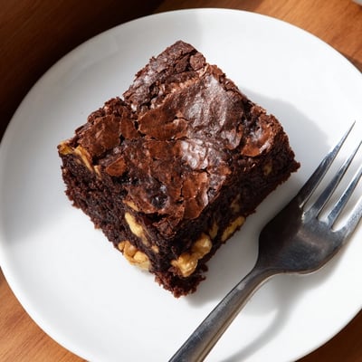 Warm ultimate brownies served with a scoop of vanilla ice cream on top
